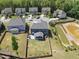 Aerial view of a neighborhood featuring a home with a large fenced yard and pond at 2527 Sidewinder Ct, Apex, NC 27523