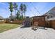Backyard space featuring an outdoor fireplace, seating, and privacy fence at 2527 Sidewinder Ct, Apex, NC 27523
