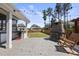 Backyard featuring an outdoor kitchen, fireplace, seating, and privacy fence at 2527 Sidewinder Ct, Apex, NC 27523