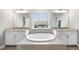 A luxurious bathroom features granite countertops, a soaking tub, and a separate vanity area at 2527 Sidewinder Ct, Apex, NC 27523