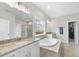 A luxurious bathroom features granite countertops, a soaking tub, and a separate glass-enclosed shower at 2527 Sidewinder Ct, Apex, NC 27523