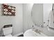 Charming half bathroom with a decorative mirror and a whimsical touch at 2527 Sidewinder Ct, Apex, NC 27523