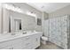Bathroom featuring double sinks with white cabinets and a shower/tub combination at 2527 Sidewinder Ct, Apex, NC 27523