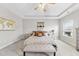 Bright bedroom boasts a tray ceiling, ceiling fan, neutral color palette, and comfortable furnishings at 2527 Sidewinder Ct, Apex, NC 27523