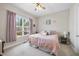 Cozy bedroom featuring a comfortable bed, soft lighting, and a view of the outdoors at 2527 Sidewinder Ct, Apex, NC 27523