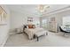 Bright bedroom boasts a tray ceiling, ceiling fan, neutral color palette, and comfortable furnishings at 2527 Sidewinder Ct, Apex, NC 27523