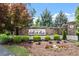 Stone community sign surrounded by lush landscaping at Preserve at White Oak offers a grand welcome at 2527 Sidewinder Ct, Apex, NC 27523
