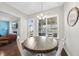Inviting dining area with a wooden table, comfortable seating, and a view of the backyard at 2527 Sidewinder Ct, Apex, NC 27523