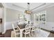 Elegant dining room with stylish lighting, wainscoting, and ample natural light from the window at 2527 Sidewinder Ct, Apex, NC 27523