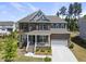 Charming two-story home with a beautifully landscaped front yard and a welcoming covered front porch at 2527 Sidewinder Ct, Apex, NC 27523