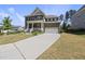 Traditional two-story home featuring a brick facade, covered porch, and two-car garage at 2527 Sidewinder Ct, Apex, NC 27523