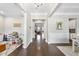 Inviting foyer with gleaming hardwood floors and elegant trim, showcasing a view through to the Gathering room at 2527 Sidewinder Ct, Apex, NC 27523