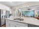 Bright kitchen boasts white cabinets, stainless steel appliances, and a granite island with seating at 2527 Sidewinder Ct, Apex, NC 27523