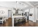 Bright kitchen boasts white cabinets, stainless steel appliances, and a granite island with seating at 2527 Sidewinder Ct, Apex, NC 27523