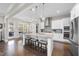 Bright kitchen boasts white cabinets, stainless steel appliances, and a granite island with seating at 2527 Sidewinder Ct, Apex, NC 27523