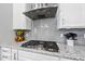 The gourmet kitchen showcases granite countertops, a stainless steel range, and grey backsplash at 2527 Sidewinder Ct, Apex, NC 27523