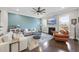 Inviting living room featuring hardwood floors, a ceiling fan, and a cozy fireplace at 2527 Sidewinder Ct, Apex, NC 27523