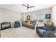 Living room with comfortable seating, neutral carpet and a ceiling fan for added comfort at 2527 Sidewinder Ct, Apex, NC 27523