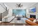 Inviting living room featuring hardwood floors, a ceiling fan, and a cozy fireplace at 2527 Sidewinder Ct, Apex, NC 27523