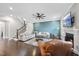 Inviting living room featuring hardwood floors, a ceiling fan, and a cozy fireplace at 2527 Sidewinder Ct, Apex, NC 27523