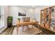 Bright home office with custom built-in shelves, a work space, and an area rug at 2527 Sidewinder Ct, Apex, NC 27523
