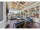 Covered patio with stone fireplace, ceiling fan, and comfortable seating perfect for entertaining at 2527 Sidewinder Ct, Apex, NC 27523