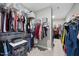 Organized walk-in closet with ample shelving and hanging space for clothing and accessories at 2527 Sidewinder Ct, Apex, NC 27523