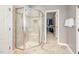 Modern bathroom featuring a glass-enclosed shower and a walk-in closet in the background at 2728 Cameron Pond Dr, Cary, NC 27519