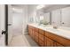 Well-lit bathroom featuring a double vanity, with a view into another room at 2728 Cameron Pond Dr, Cary, NC 27519