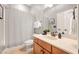 Bathroom features a vanity, a toilet, and a tub with a striped shower curtain at 2728 Cameron Pond Dr, Cary, NC 27519