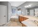Bathroom featuring a soaking tub, dual vanity, and neutral tile at 2728 Cameron Pond Dr, Cary, NC 27519