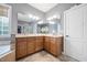Bathroom featuring double sinks, tile flooring, and a large mirror at 2728 Cameron Pond Dr, Cary, NC 27519