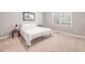 Cozy bedroom with neutral carpet, a window, and a comfortable bed at 2728 Cameron Pond Dr, Cary, NC 27519