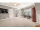 Spacious bedroom with a ceiling fan, large clock on wall and a view into the en-suite bathroom at 2728 Cameron Pond Dr, Cary, NC 27519