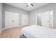 Neutral bedroom featuring a ceiling fan, soft carpeting, and double door closets for maximum storage at 2728 Cameron Pond Dr, Cary, NC 27519