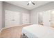 Spacious bedroom with a ceiling fan, double closets, and a doorway at 2728 Cameron Pond Dr, Cary, NC 27519
