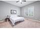 Neutral bedroom features carpet, ceiling fan, and a large window at 2728 Cameron Pond Dr, Cary, NC 27519