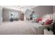A spacious bonus room features a ceiling fan, plush carpet, natural light, and ample sitting space at 2728 Cameron Pond Dr, Cary, NC 27519