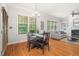 Dining area featuring a wood table set with chairs and natural light from two large windows at 2728 Cameron Pond Dr, Cary, NC 27519
