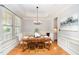 Elegant dining room with hardwood floors, tray ceiling, and wainscoting, ideal for formal gatherings at 2728 Cameron Pond Dr, Cary, NC 27519