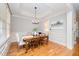 Charming dining room features hardwood floors, natural light, and a view of the butler's pantry at 2728 Cameron Pond Dr, Cary, NC 27519