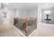 Second floor landing featuring a staircase and a view of the laundry room and a secondary bedroom at 2728 Cameron Pond Dr, Cary, NC 27519