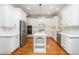 Stylish kitchen with white cabinetry, stainless steel appliances, and a center island, perfect for cooking and entertaining at 2728 Cameron Pond Dr, Cary, NC 27519