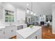 Open-concept kitchen featuring stainless steel appliances, a kitchen island, and bright natural light at 2728 Cameron Pond Dr, Cary, NC 27519