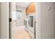 Well-lit laundry room with modern washer and dryer, and cabinets above at 2728 Cameron Pond Dr, Cary, NC 27519