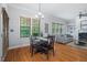 Open-concept living and dining area with hardwood floors, large windows, and a fireplace feature wall at 2728 Cameron Pond Dr, Cary, NC 27519