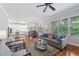 Open-concept living area with hardwood floors, a ceiling fan, and seamless flow to the kitchen at 2728 Cameron Pond Dr, Cary, NC 27519