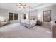 Spacious main bedroom featuring a tray ceiling, plush carpeting, and stylish furnishings at 2728 Cameron Pond Dr, Cary, NC 27519