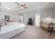 Spacious bedroom features a four-poster bed, sitting area, and neutral tones at 2728 Cameron Pond Dr, Cary, NC 27519