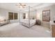 The main bedroom features a four-poster bed frame, tray ceilings, and neutral carpet at 2728 Cameron Pond Dr, Cary, NC 27519